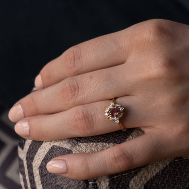 0.76ct natural unheated pink sapphire ring in 18k yellow gold with diamond accents on hand